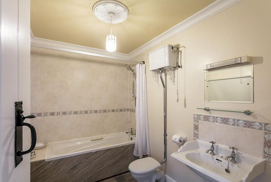 A bathroom with a bathtub, toilet, and sink.