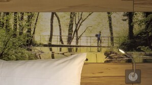 A bed with white bedding, a wooden headboard, and a wall-mounted nightstand with a lamp. - Ibis Styles Sarrebourg Hotel (Sarrebourg)