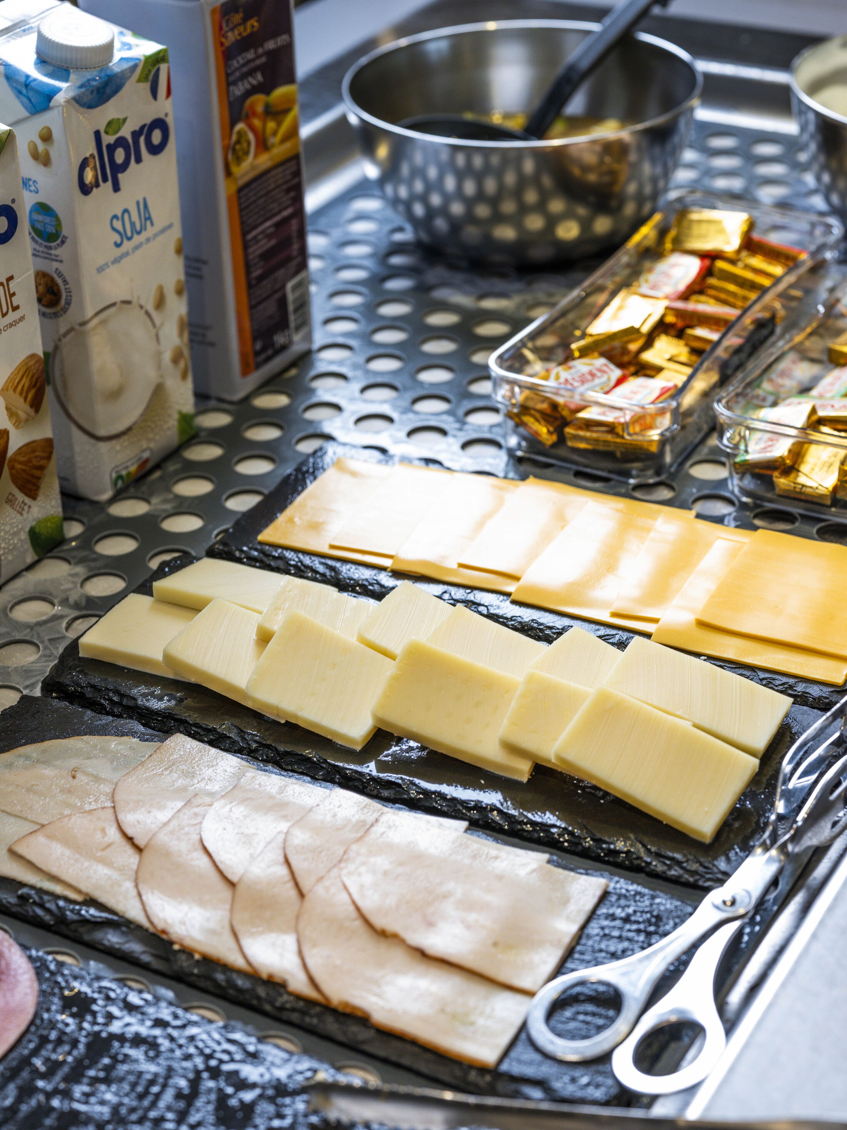 A table with various food items including cheese, nuts, and a carton of milk.
