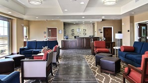 A hotel lobby with seating areas, a reception desk, and a patterned floor. - Comfort Inn Midland South I-20 (Midland)