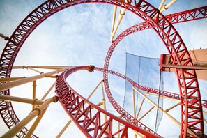 A roller coaster track with a clear sky in the background.