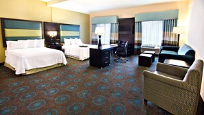 A hotel room with two beds, a desk, a chair, a sofa, and a TV. - Hampton Inn & Suites Salt Lake City/Farmington (Farmington)