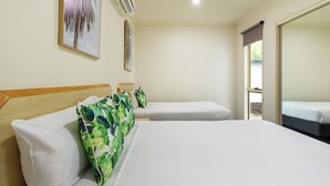 A hotel room with two beds, a large mirror, and a ceiling fan. - Red Bridge Motor Inn (Woombye)