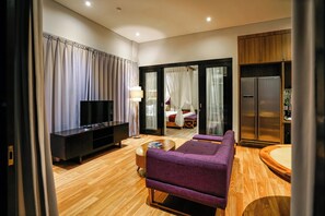 Penthouse | Living area | 40-inch LED TV with cable channels, TV - The Kirana Canggu Hotel (Canggu)