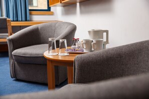 Relax in comfort with a cozy armchair and convenient side table.