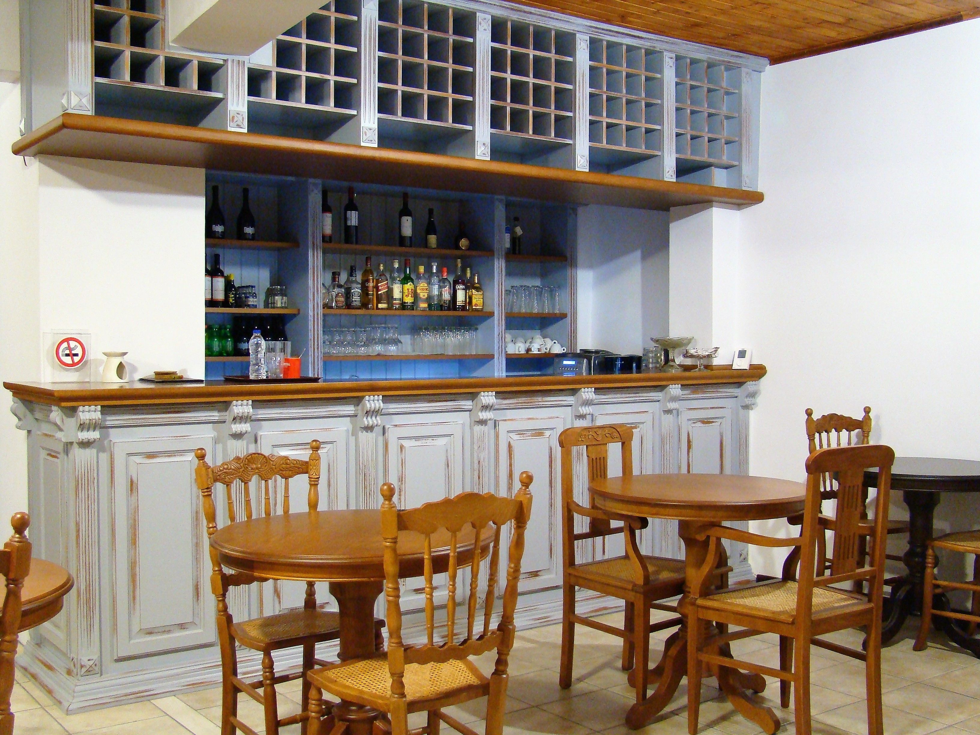 A bar area with wooden chairs and a counter.