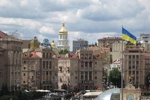 A historic building with classical architecture, a McDonald's restaurant, and a Ukrainian flag.