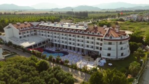 A large hotel with multiple floors, a swimming pool, and a landscaped courtyard. - Dalaman Airport Lykia Thermal & Spa Hotel (Dalaman)