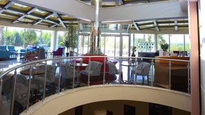 A multi-level atrium with glass railings, seating areas, and a central staircase. - Dalaman Airport Lykia Thermal & Spa Hotel (Dalaman)