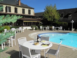 Seasonal outdoor pool, open 6:00 AM to 9:00 PM, pool umbrellas