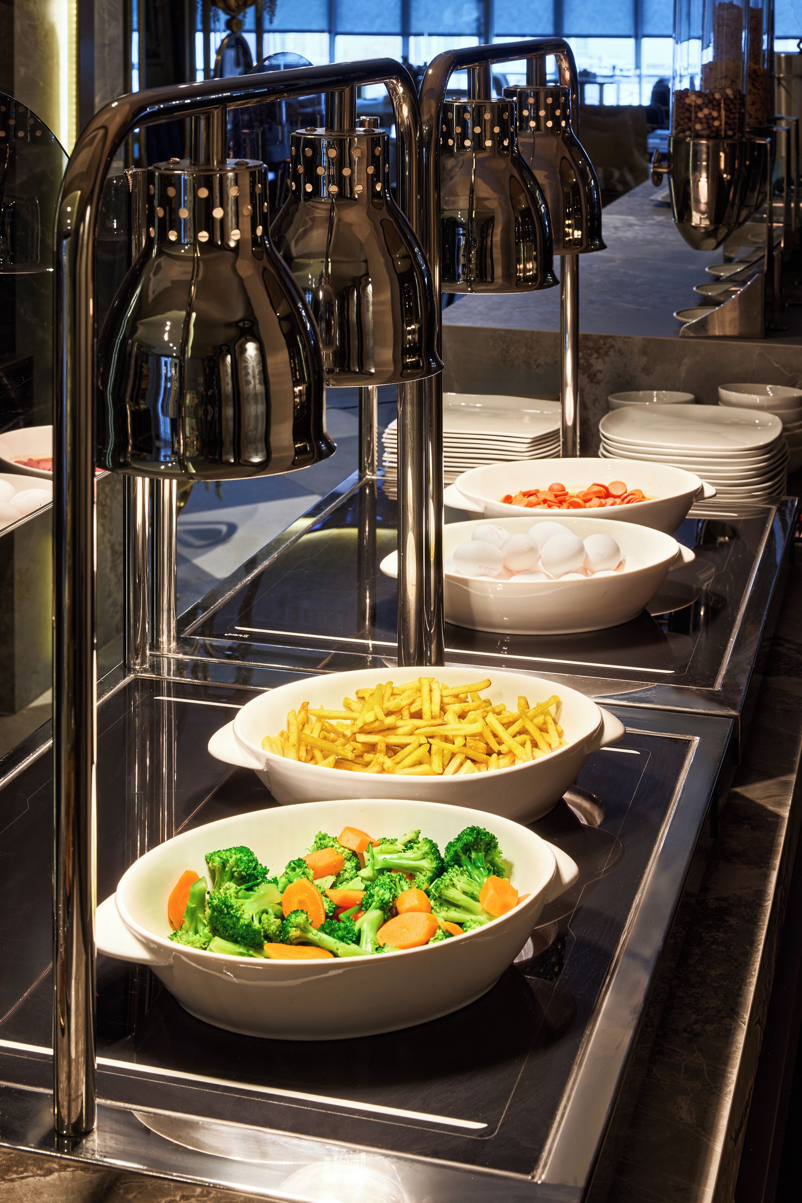 A buffet setup with various food items and a beverage dispenser.