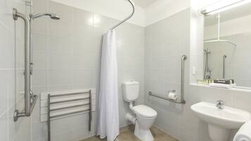 A modern bathroom with a shower, toilet, and sink.
