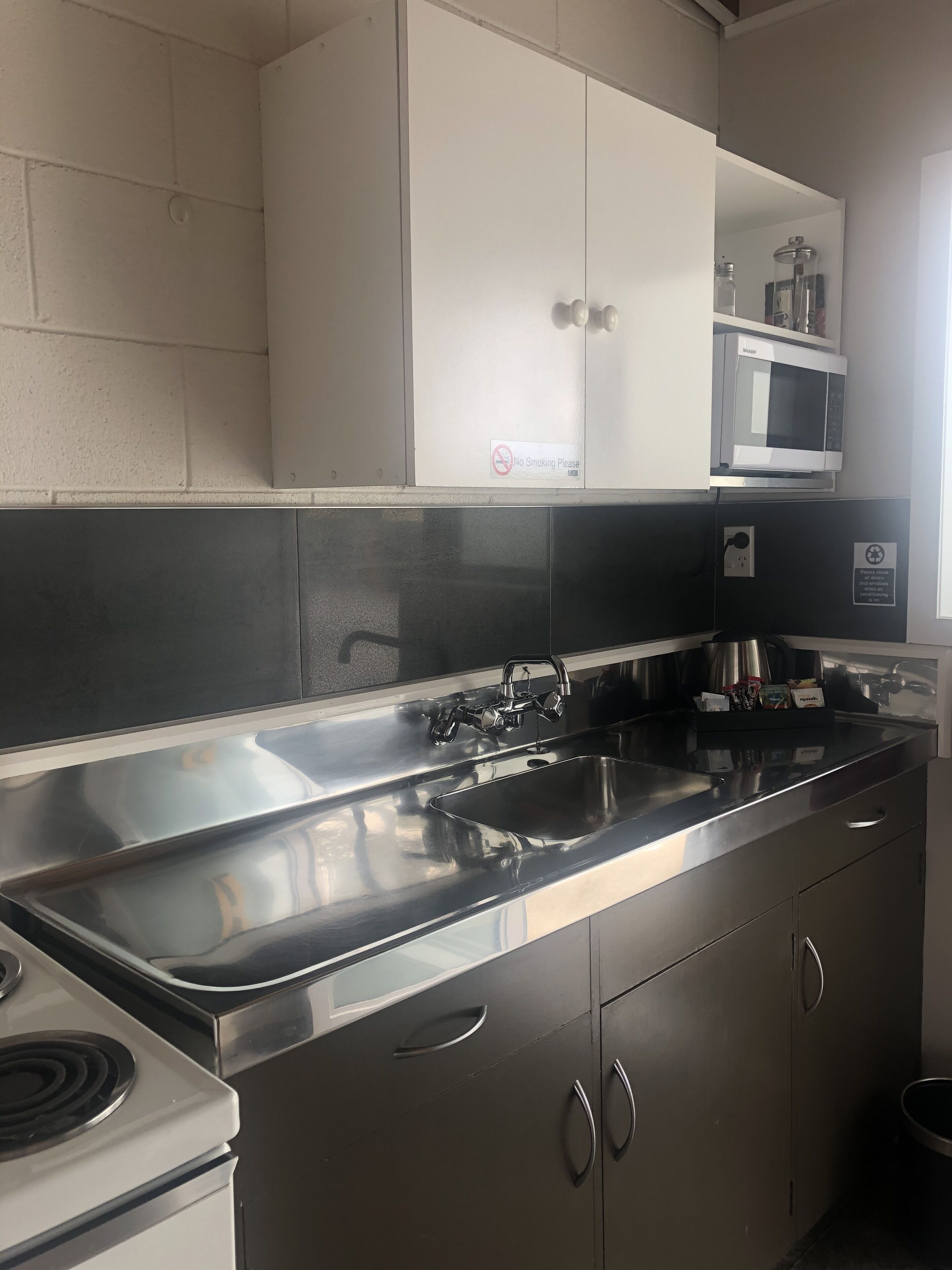 A kitchen with stainless steel appliances, a double sink, and cabinets.