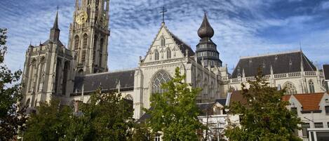 A historic cathedral with intricate architecture, including a tall spire and multiple towers.