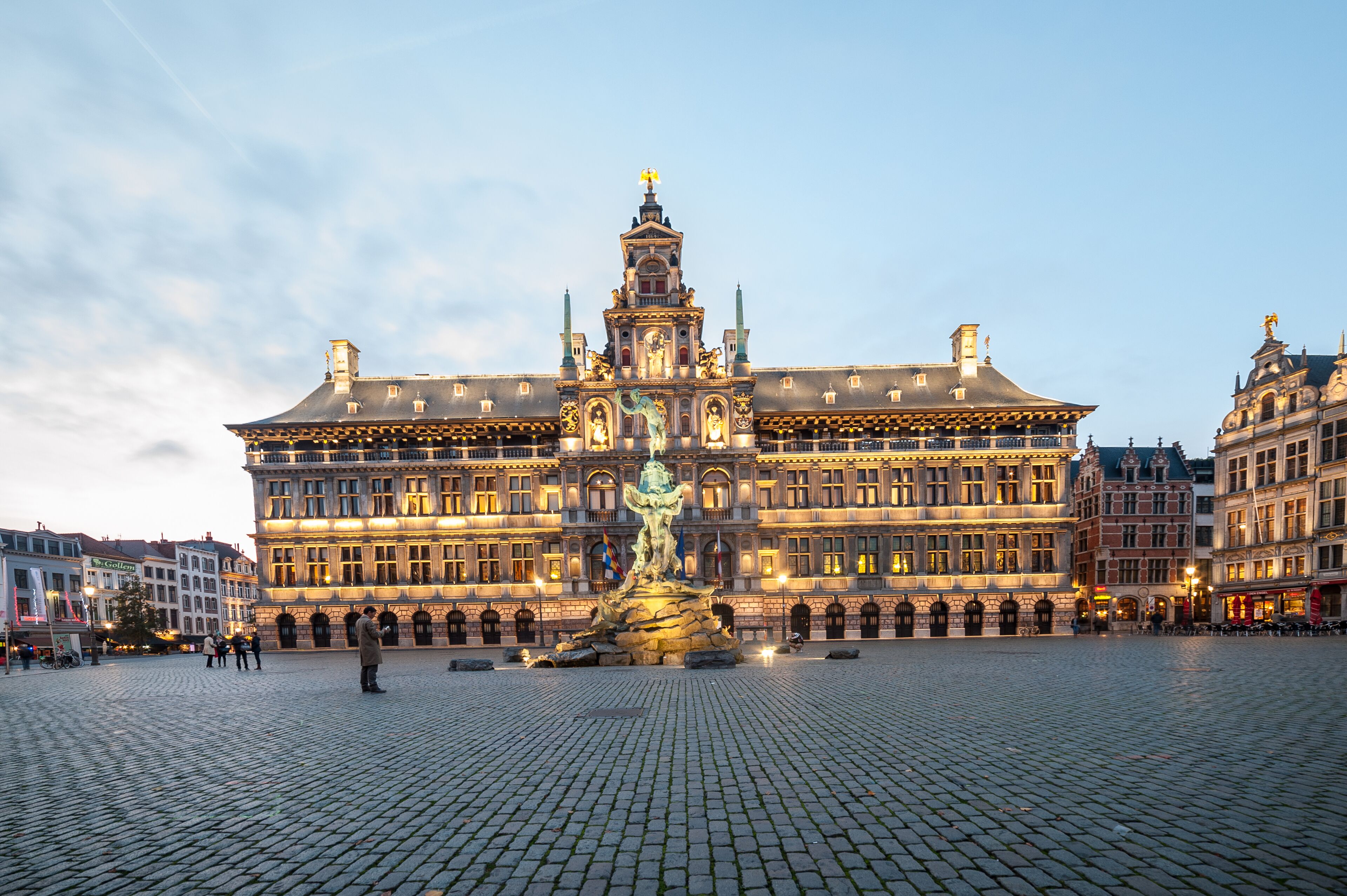 A historic building with a central fountain, large windows, and a symmetrical facade.