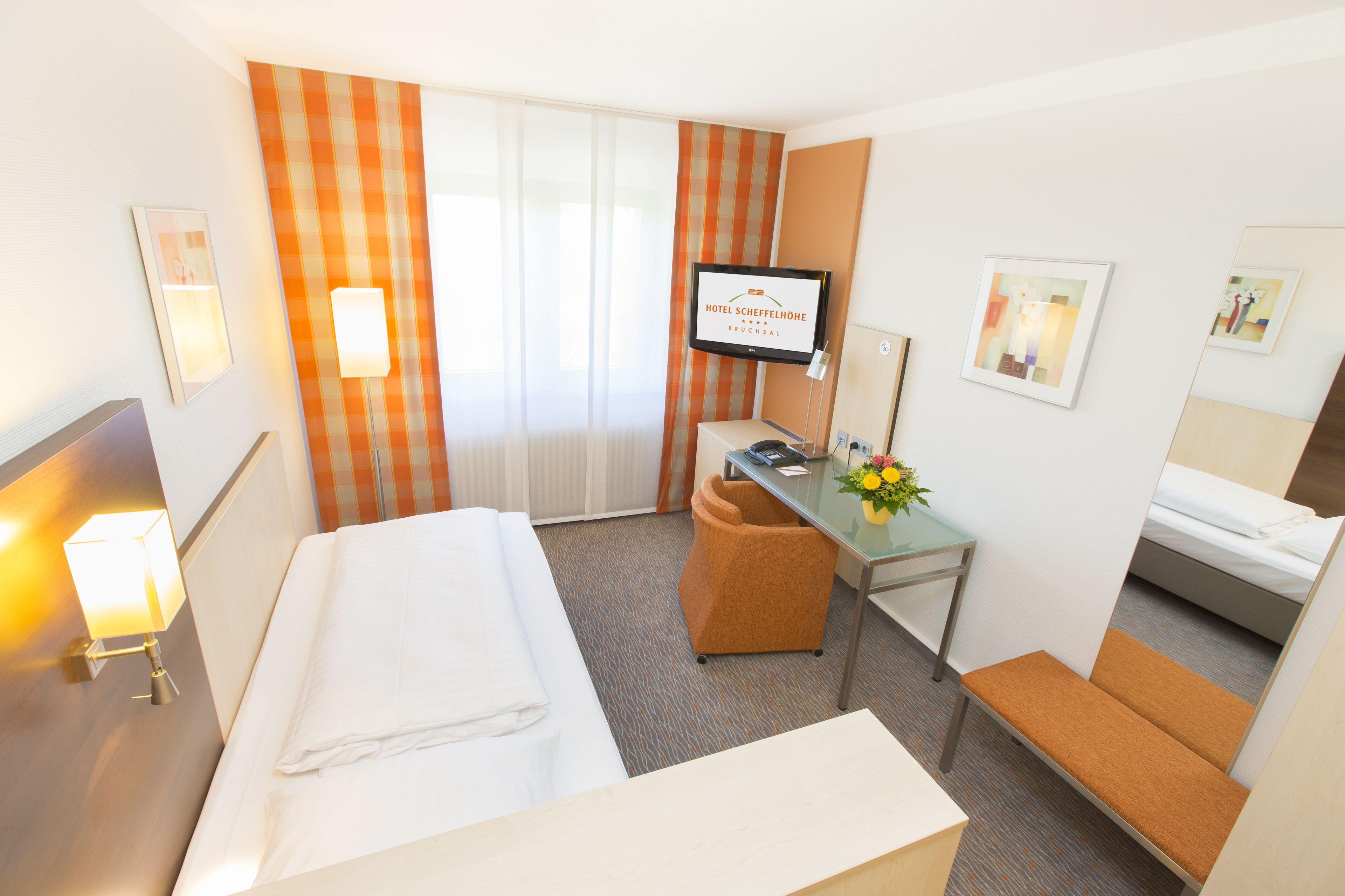 economy room | minibar, in-room safe, desk, iron/ironing board