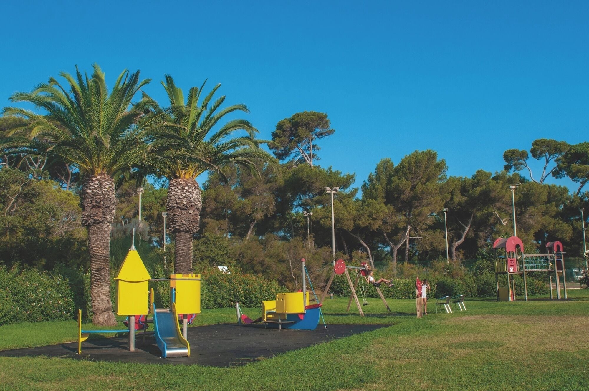 A playground with a slide, swings, and climbing structures.