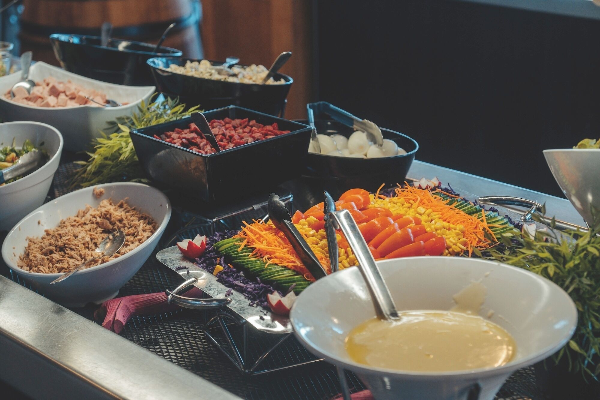 Een buffet met diverse gerechten en bestek.