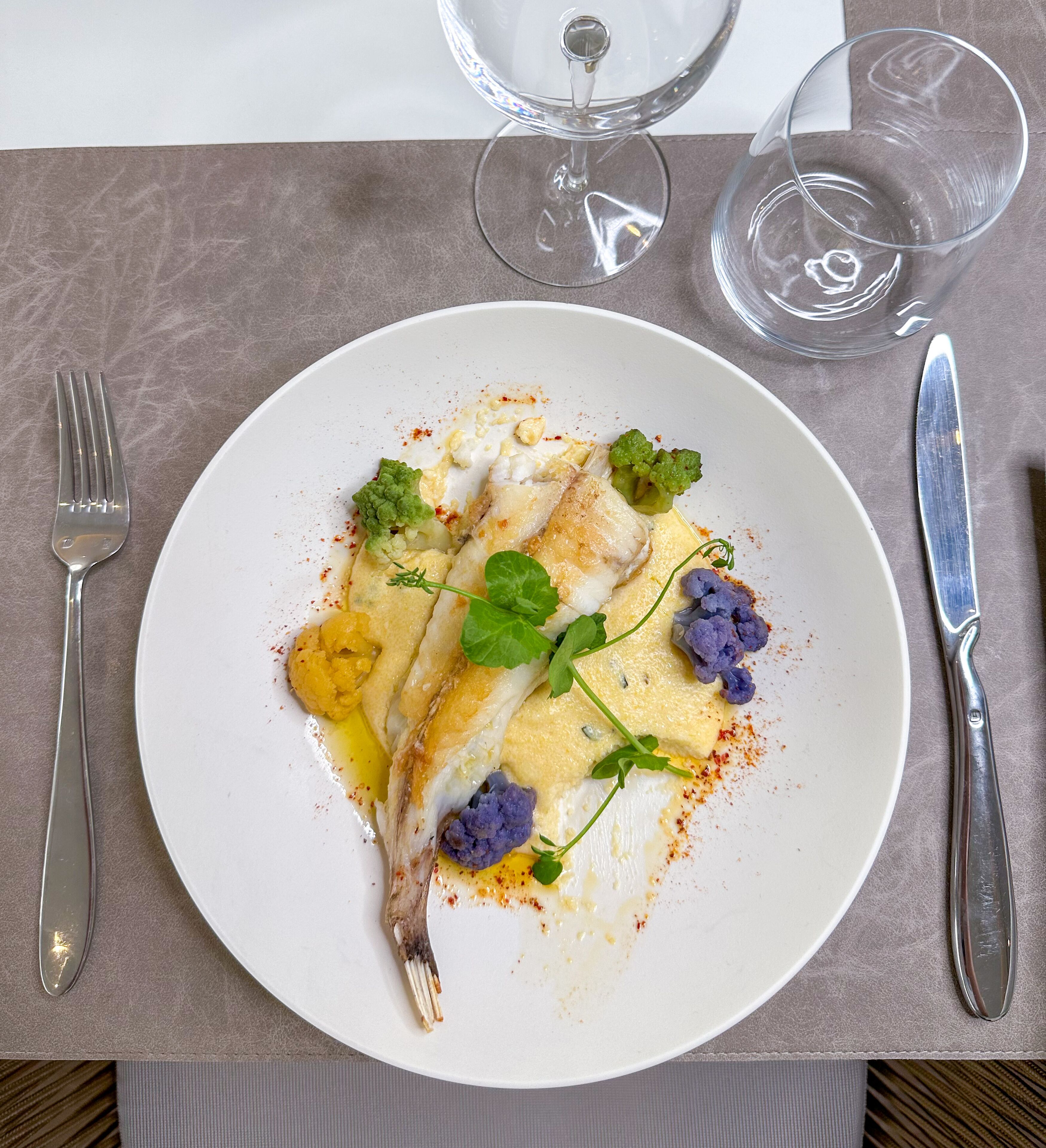 Un plato de comida con un tenedor y un cuchillo sobre la mesa.