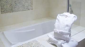 A bathroom with a bathtub and a towel rack.