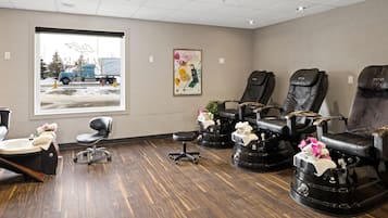 Relax in comfort with three massage chairs, a stool, and a single chair, offering a peaceful retreat.