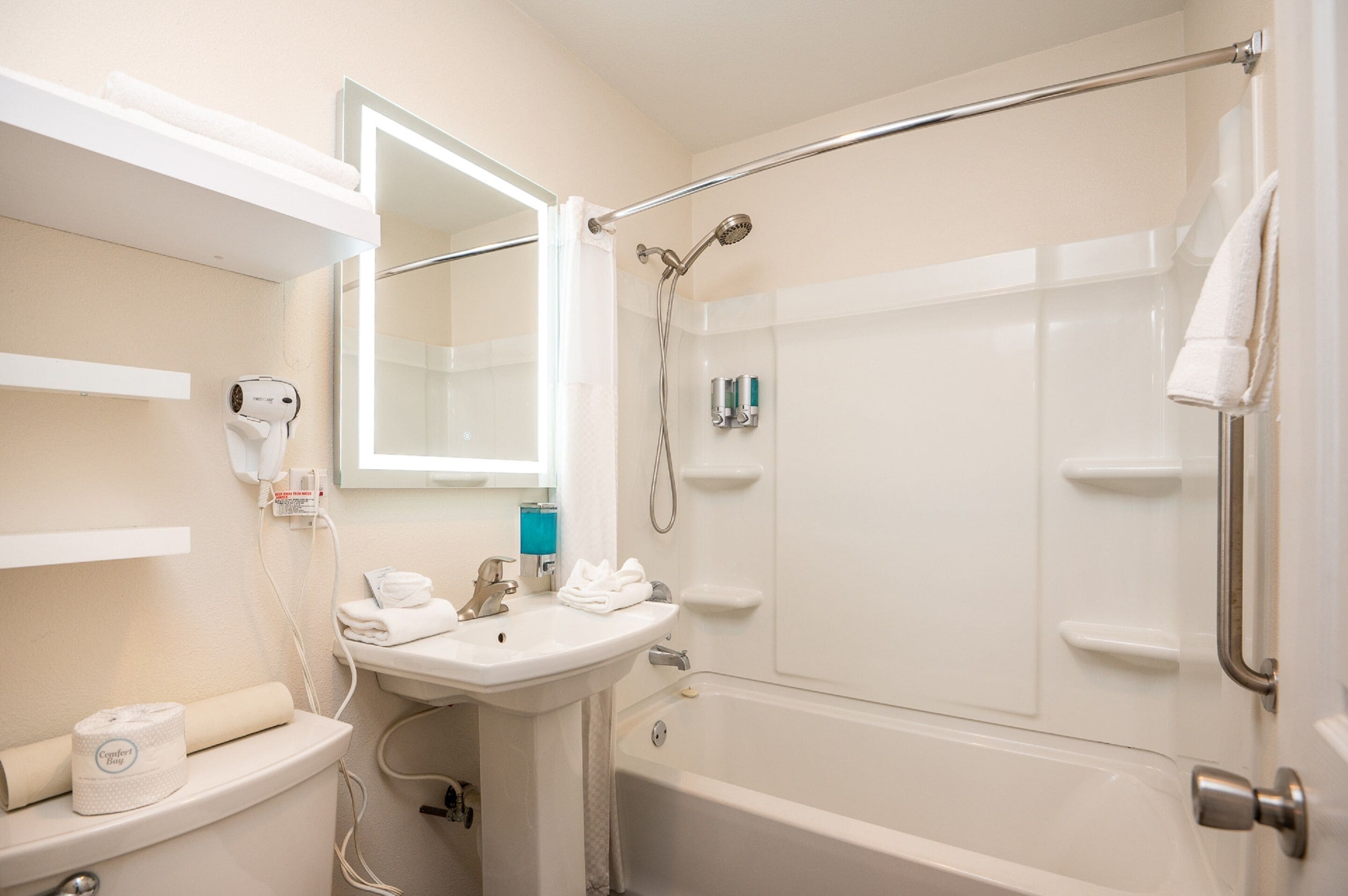 A bathroom with a sink, toilet, and shower.