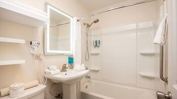 A bathroom with a sink, toilet, and shower.