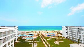 A resort with multiple buildings, a pool area, and a beach. - Hotel Riu Playa Blanca - All Inclusive (Rio Hato)