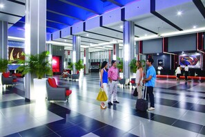 Relax in the spacious lobby with comfortable seating areas and lush greenery.
