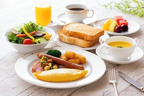 A breakfast setting with toast, sausage, omelette, salad, fruit, coffee, and juice. - Okura Act City Hotel Hamamatsu (Hamamatsu)
