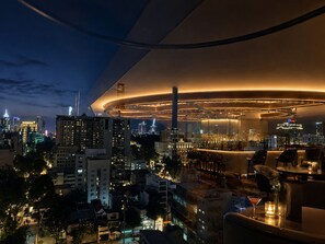A modern hotel with a rooftop bar, city views, and a unique circular architectural design. - G8 Center Hotel Saigon (Ho Chi Minh City)