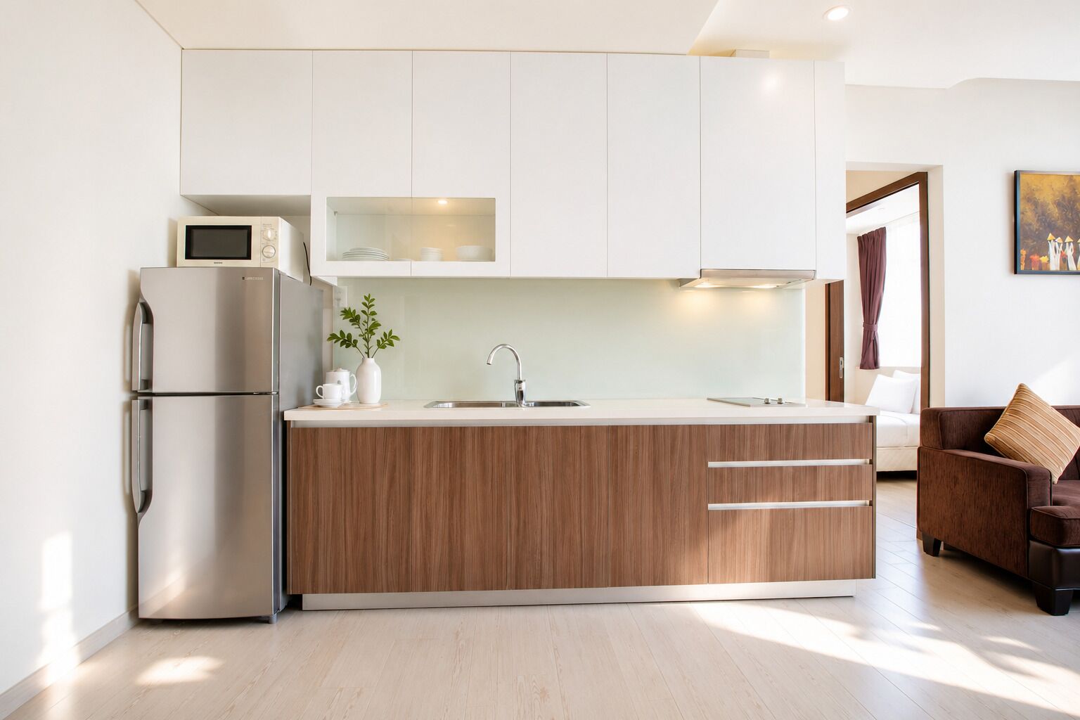 A modern kitchen with a built-in refrigerator, a sink, and a wooden countertop.