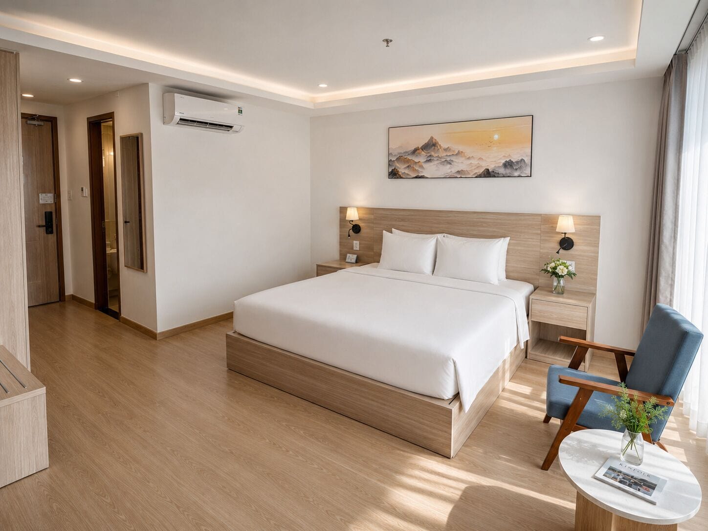 A hotel room with a large bed, bedside tables, a chair, a small table with a vase, and a painting on the wall.