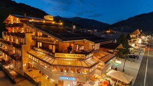 A hotel with a restaurant named "Sparkasse" and a sign for "Hotel Sportalm." - Hotel Sportalm (Gerlos)