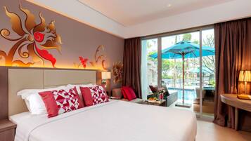A hotel room with a large bed, a view of a swimming pool, and a decorative wall mural.