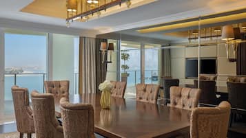 A spacious conference room with a large table, multiple chairs, and a view of the cityscape through large windows.