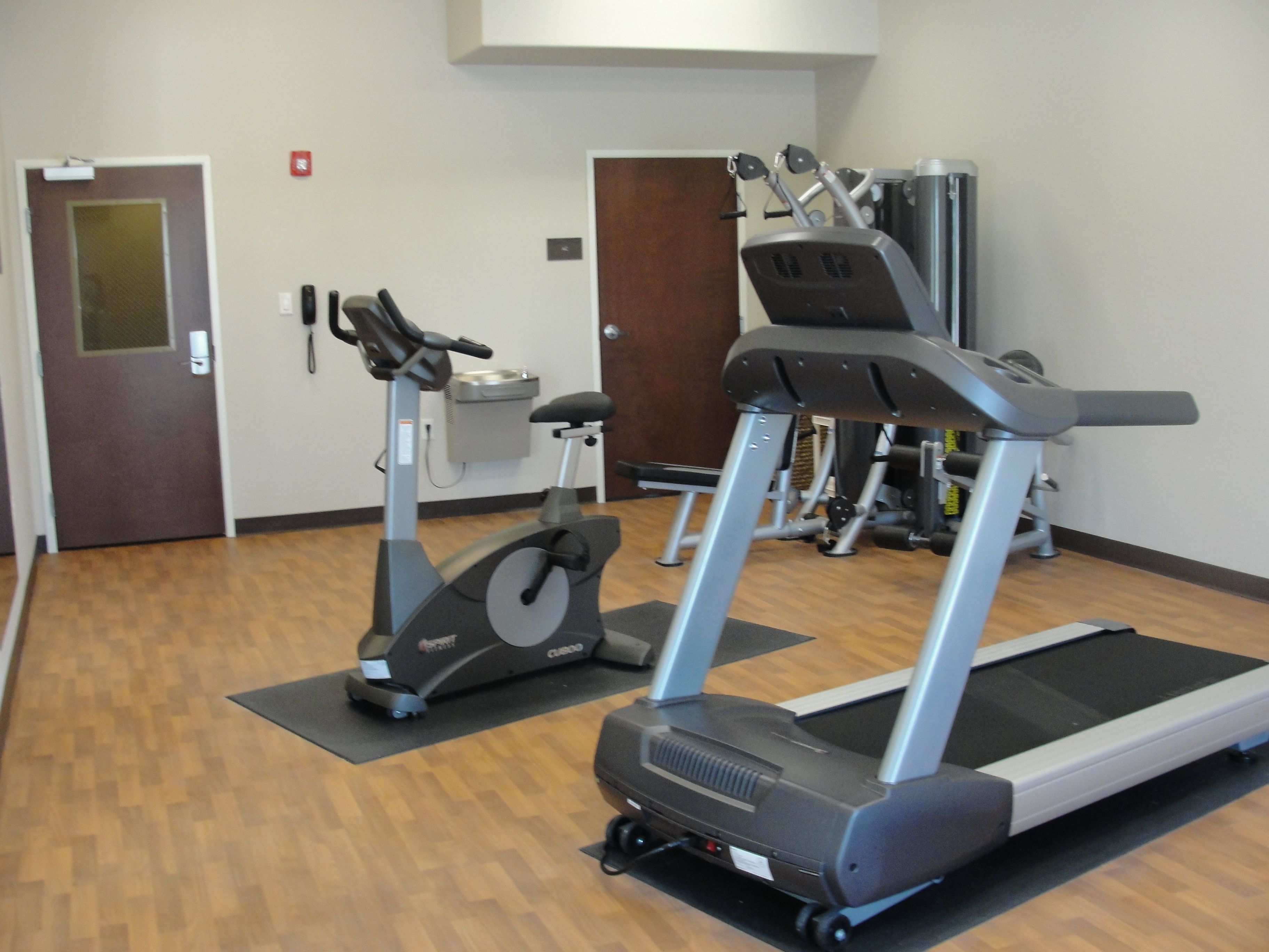 A gym with stationary bikes, treadmills, and exercise equipment.