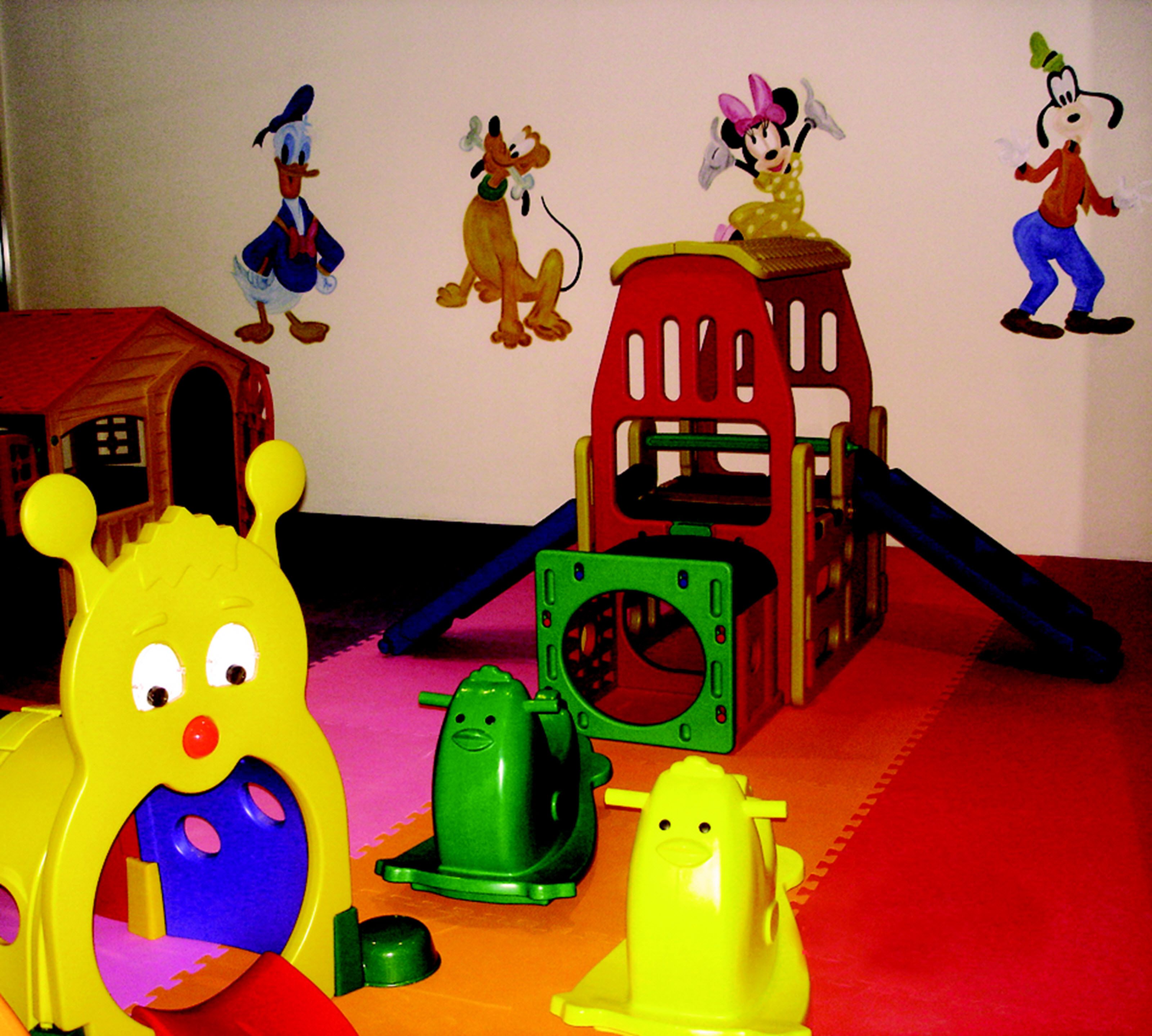 A children's play area with colorful toys and a slide.