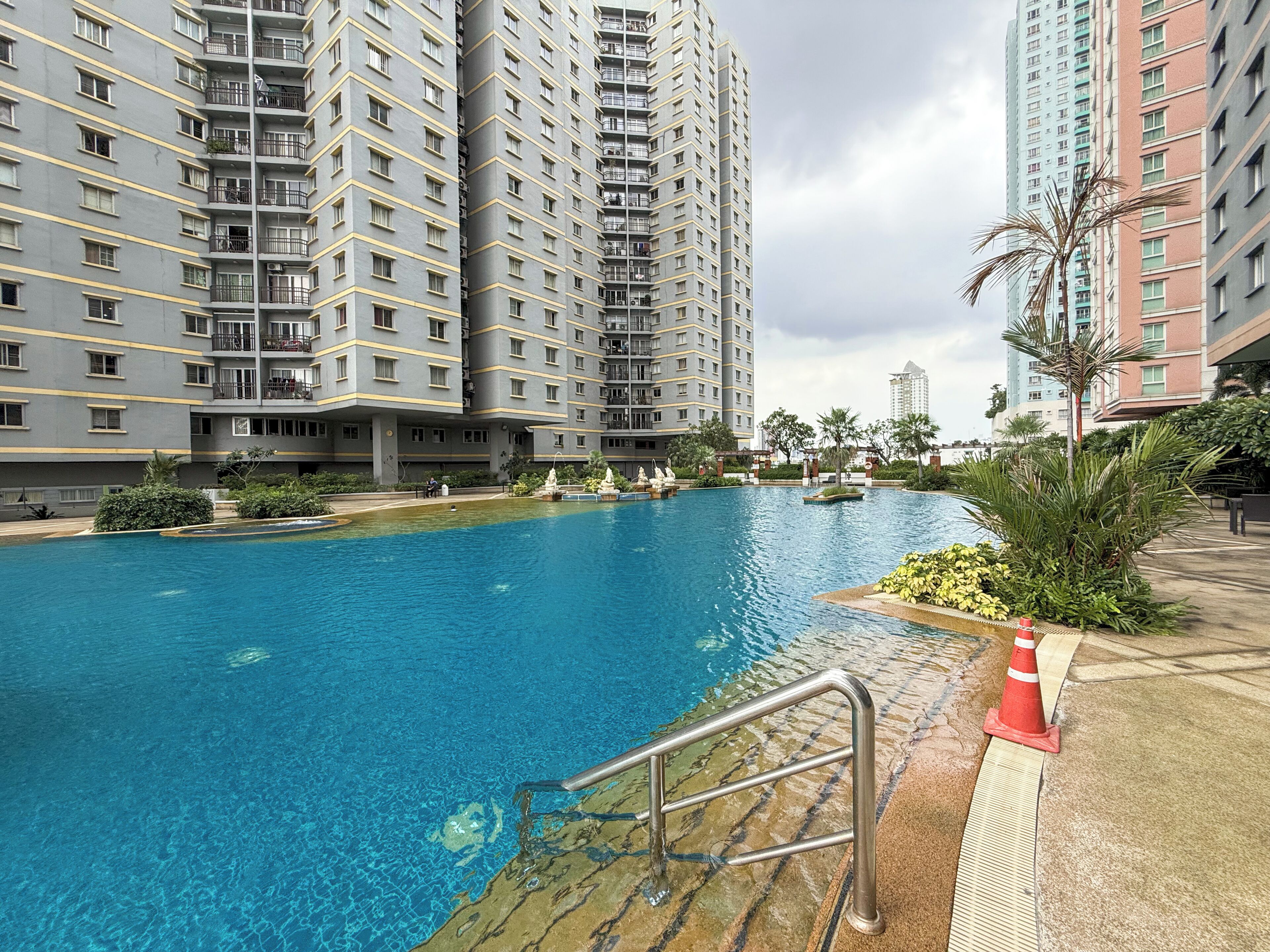 A swimming pool surrounded by high-rise residential buildings.