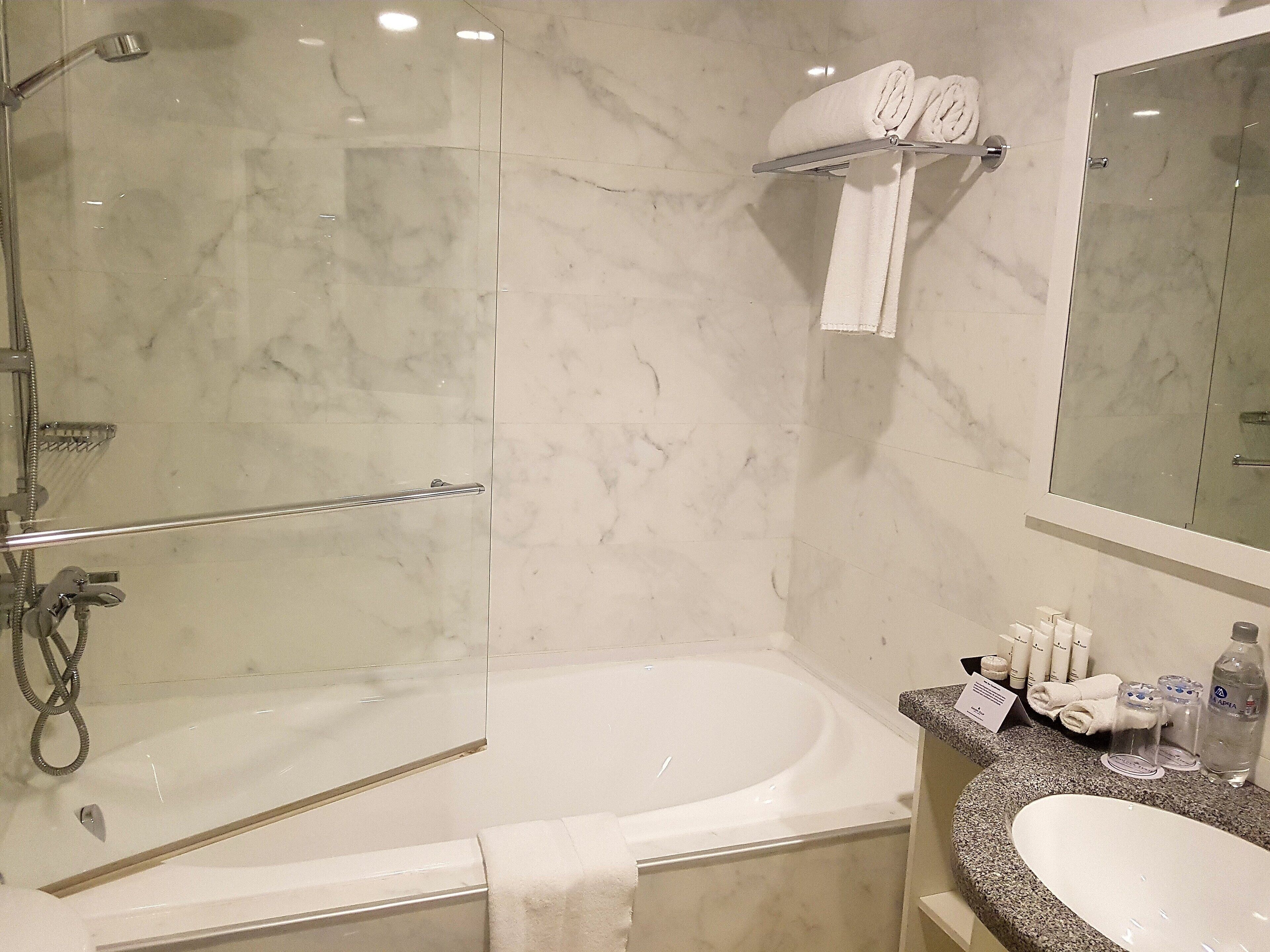 junior suite, 1 king bed, non smoking | bathroom | bathtub, hair dryer, bathrobes, towels