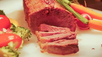 A close-up of a cooked meat dish with vegetables.