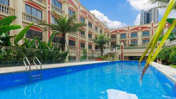 Outdoor pool, open 9:00 AM to 8:30 PM, pool umbrellas