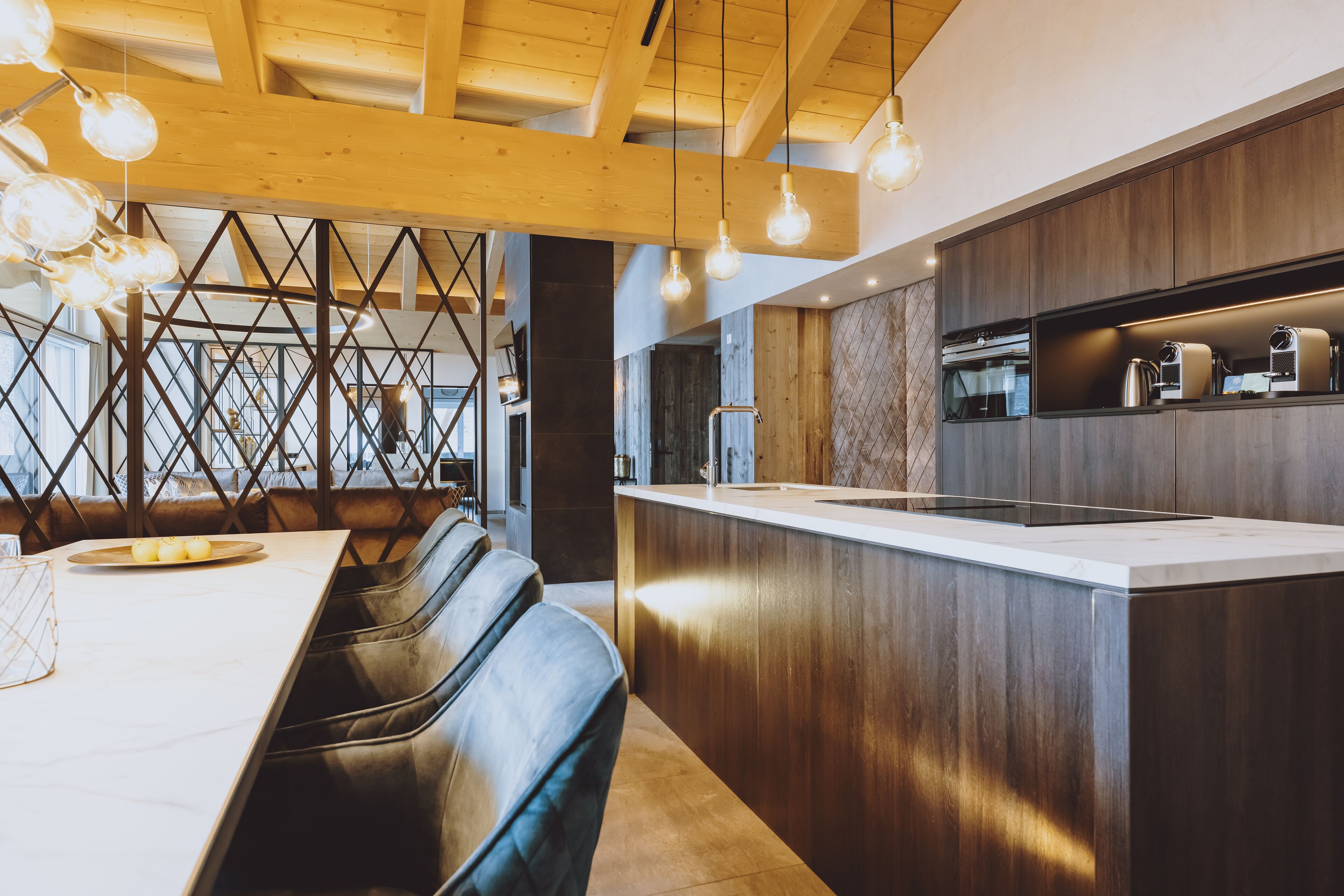 A modern kitchen with a wooden ceiling, built-in appliances, and a bar area.