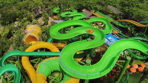 A water park with multiple green and yellow water slides. - ZIA Hotel Kuta (Kuta)