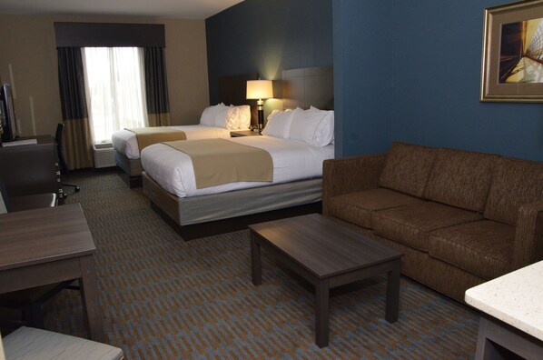 A hotel room with two beds, a sofa, a desk, and a TV. - Holiday Inn Express Hotel & Suites Goldsboro - Base Area by IHG (Goldsboro)