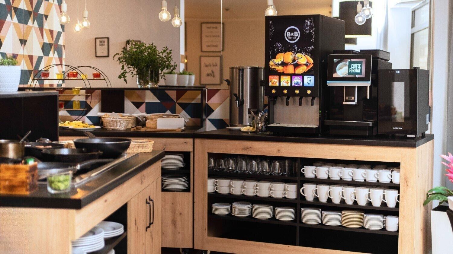 A coffee bar with a coffee machine, a menu display, and shelves with cups and plates.