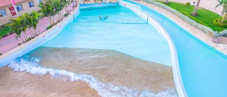A water park with a wave pool, palm trees, and a building labeled "RED SEA".