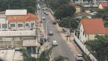 A street view with buildings, cars, and pedestrians.