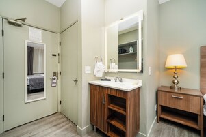 Shower, designer toiletries, hair dryer, towels