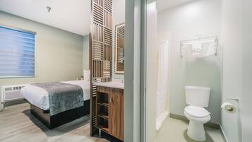 A modern bathroom with a toilet, sink, and shower area.